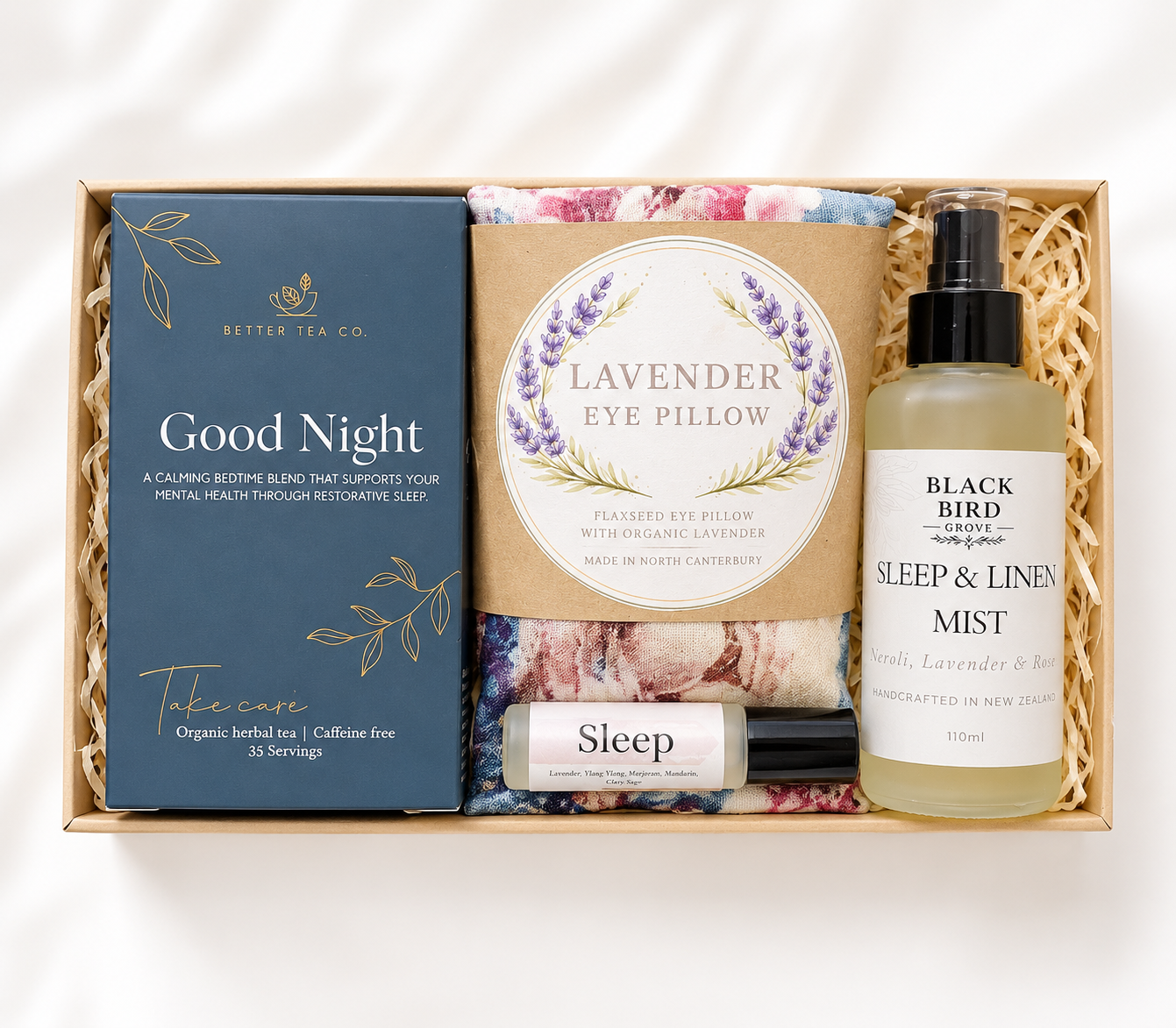 Gift set with lavender eye pillow, tea, and mist bottle on a white background